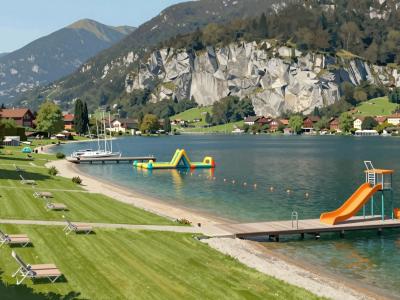 AI-generated illustration of the lakeside lido at Mondsee with the Drachenwand cliffs behind