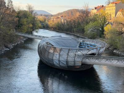 Murinsel floating platform on the Mur River in Graz, seen from the riverbank