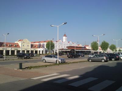 Village-style storefronts and clock tower at Designer Outlet Parndorf, Burgenland