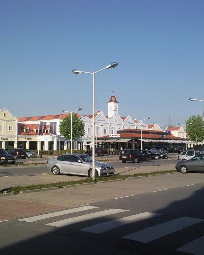 Village-style storefronts and clock tower at Designer Outlet Parndorf, Burgenland