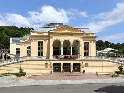 A large, yellow neoclassical building with a central pediment and arched portico, identified by the text "CASINO CONGRESS" above the entrance and a "BADEN" watermark on the left side.