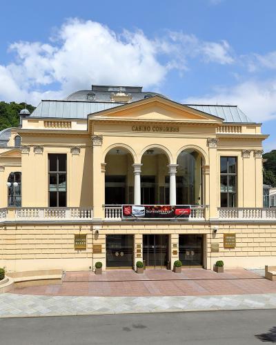 A large, yellow neoclassical building with a central pediment and arched portico, identified by the text "CASINO CONGRESS" above the entrance and a "BADEN" watermark on the left side.