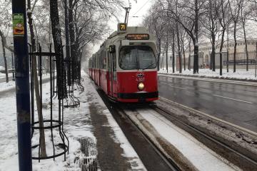 A red Vienna tram on the Ringstrasse