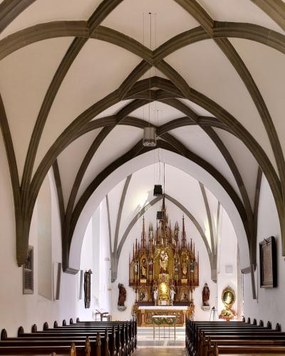 Gothic star-vaulted nave of Feldkirch Cathedral looking toward the altar
