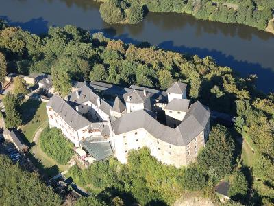 Aerial view of Lockenhaus Castle on its wooded hill in Burgenland