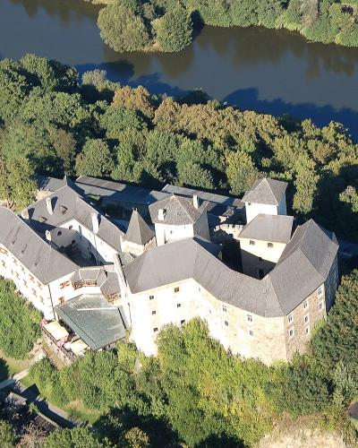 Aerial view of Lockenhaus Castle on its wooded hill in Burgenland