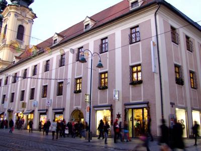 Historic buildings and shoppers along Landstrasse in Linz