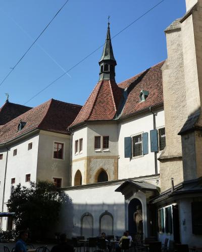 Franciscan Church and monastery with its Gothic tower on Franziskanerplatz in Graz, Austria