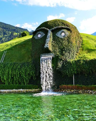The grass-covered Giant head with waterfall at Swarovski Crystal Worlds in Wattens