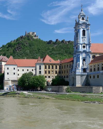Dürnstein Abbey with its blue-and-white baroque tower on the Danube, castle ruins above