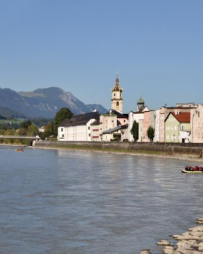 Pastel riverfront houses and church towers of Rattenberg on the Inn river, Tyrol