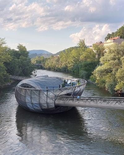 Murinsel, the floating steel shell island by Vito Acconci on the Mur river in Graz