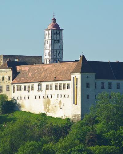 Schallaburg Renaissance castle with its patterned tower rising above wooded slopes in Lower Austria