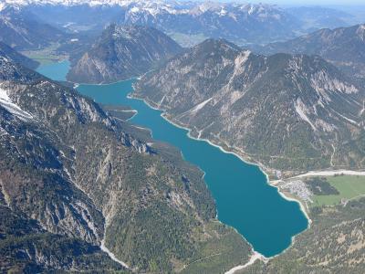 Aerial view of the turquoise Plansee lake framed by Tyrolean mountains near Reutte