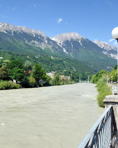 Inn River in Innsbruck with riverside houses and the Nordkette mountain range