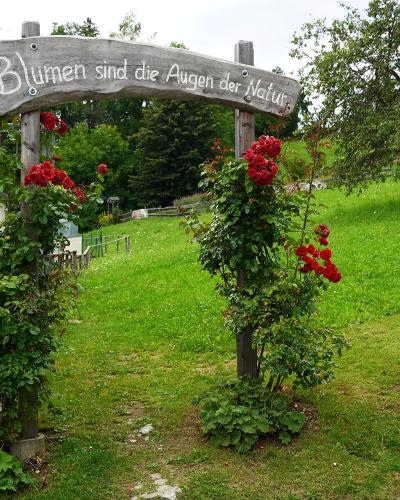 Rose-covered entrance arch in Irschen, a Slow Food Village in Carinthia, Austria