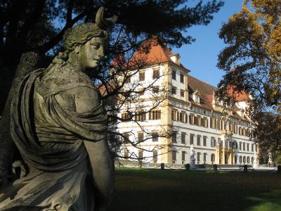 Baroque facade of Eggenberg Palace in Graz seen from the park with Diana statue
