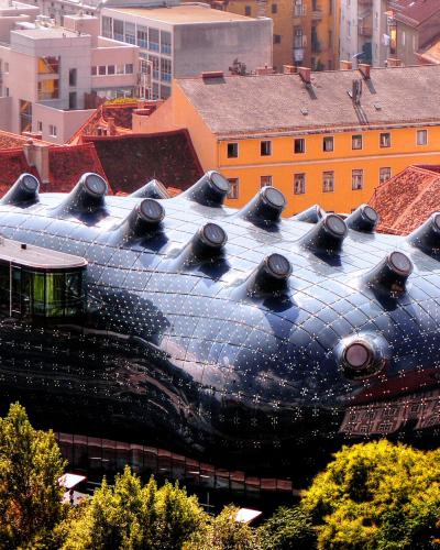 Kunsthaus Graz's blue biomorphic roof amid the red rooftops of Graz's UNESCO-listed Old Town