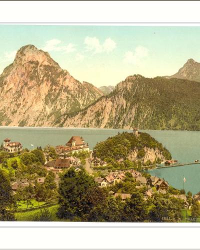 A vintage colorized postcard showing the village of Traunkirchen on the shore of Lake Traunsee with the Traunstein mountain rising prominently in the background.