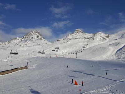 Ski slopes and chairlifts of the Silvretta Arena ski area above Ischgl under a blue sky