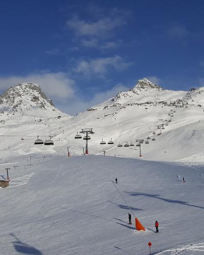 Ski slopes and chairlifts of the Silvretta Arena ski area above Ischgl under a blue sky